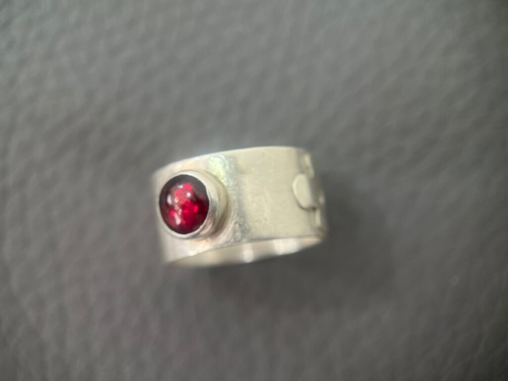 Silver ring with round garnet