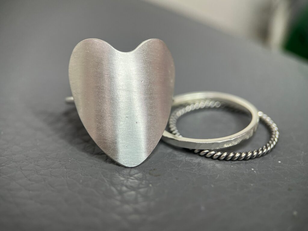 Large silver heart ring and two silver bands